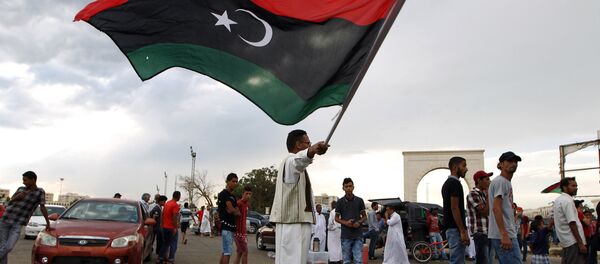 A Libyan man waves his national flag A Libyan man waves his national flag - Sputnik International
