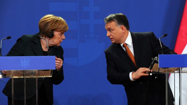 German Chancellor Angela Merkel (L) chats with her host Hungarian Prime Minister Viktor Orban (R) in the parliament building of Budapest on February 2, 2015 during their joint press conference during her first visit to Hungary in last five years. - Sputnik International