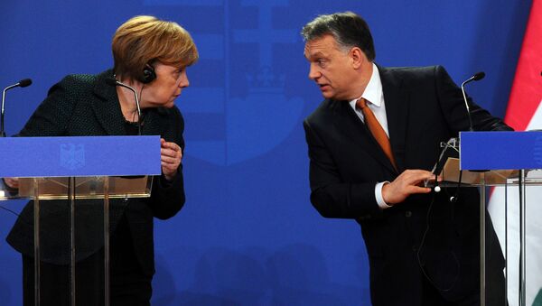German Chancellor Angela Merkel (L) chats with her host Hungarian Prime Minister Viktor Orban (R) in the parliament building of Budapest on February 2, 2015 during their joint press conference during her first visit to Hungary in last five years. - Sputnik International