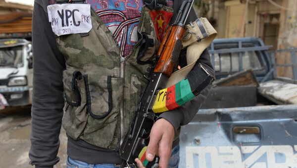 A Kurdish fighter from the Popular Protection Units (YPG) is pictured in the majority-Kurdish Sheikh Maqsud district of the northern Syrian city of Aleppo, on April 21, 2013. - Sputnik International