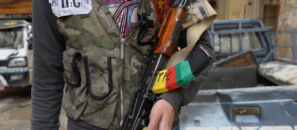 A Kurdish fighter from the Popular Protection Units (YPG) is pictured in the majority-Kurdish Sheikh Maqsud district of the northern Syrian city of Aleppo, on April 21, 2013. A Kurdish fighter from the Popular Protection Units (YPG) is pictured in the majority-Kurdish Sheikh Maqsud district of the northern Syrian city of Aleppo, on April 21, 2013. - Sputnik International