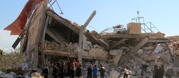 People gather around the rubble of a hospital supported by Doctors Without Borders (MSF) near Maaret al-Numan, in Syria's northern province of Idlib, on February 15, 2016 People gather around the rubble of a hospital supported by Doctors Without Borders (MSF) near Maaret al-Numan, in Syria's northern province of Idlib, on February 15, 2016 - Sputnik International