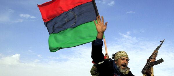A rebel soldier gestures atop a car as he heads to Brega, in Ajdabiya March 2, 2011. A rebel soldier gestures atop a car as he heads to Brega, in Ajdabiya March 2, 2011. - Sputnik International