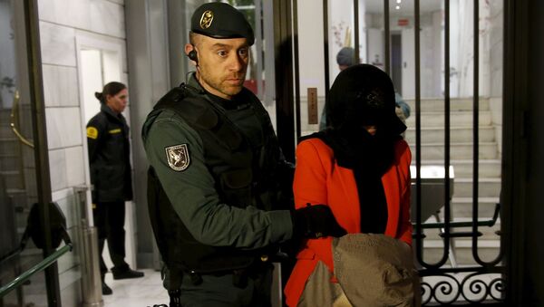 A suspect is led by a Spanish Civil Guard officer as they leave the headquarters of Industrial and Commercial Bank of China (ICBC) during a raid in Madrid, Spain, February 17, 2016 - Sputnik International