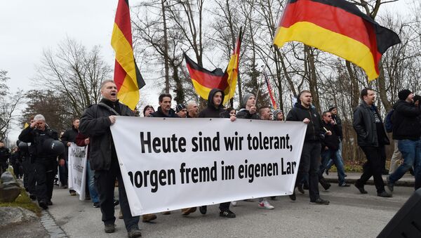 Protesters of the far right league We are the border (Wir sind die Grenze) carry a banner reading Today tolerant, tomorrow a stranger in his own country during a demonstration in Freilassing, southern Germany, on January 9, 2016. - Sputnik International