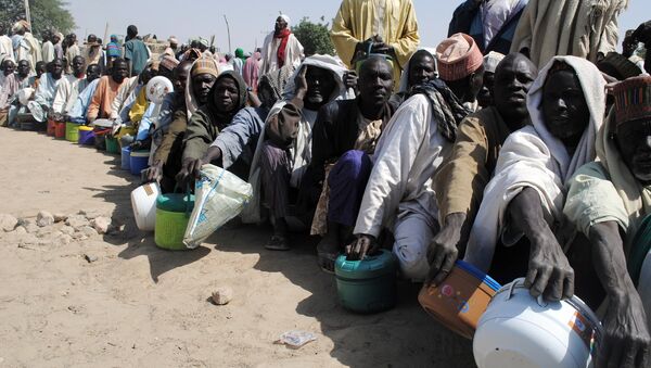 Internally Displaced Persons (IDP) mostly men sit in line waiting to be served with food at Dikwa Camp, in Borno State in north-eastern Nigeria, on February 2, 2016 - Sputnik International