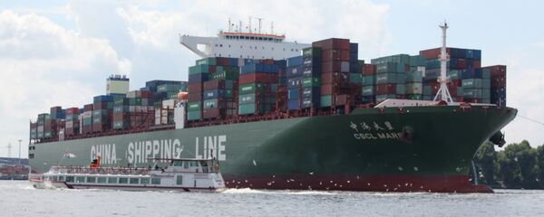 Two people sit on the beach and watch the CSCL Mars container ship of the China Shipping company (File) Two people sit on the beach and watch the CSCL Mars container ship of the China Shipping company (File) - Sputnik International