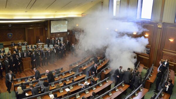 Opposition politicians release tear gas in parliament to obstruct a session in Pristina, Kosovo February 19, 2016 - Sputnik International