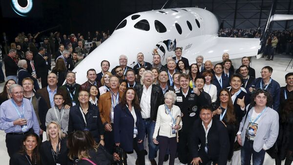 Sir Richard Branson (C) poses with his mother Eve (C-R) and future astronauts after unveiling the new SpaceShipTwo, a six-passenger two-pilot vehicle meant to ferry people into space that replaces a rocket destroyed during a test flight in October 2014, in Mojave, California, United States, February 19, 2016 - Sputnik International