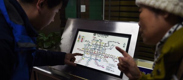 An attendant (L) explains details of new charges to a commuter in front of a subway map at a subway station in Beijing on December 29, 2014 An attendant (L) explains details of new charges to a commuter in front of a subway map at a subway station in Beijing on December 29, 2014 - Sputnik International