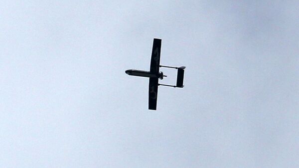 A drone belonging to the Ezzedine al-Qassam Brigades, Hamas' armed wing, flies over Gaza City on December 14, 2014 - Sputnik International