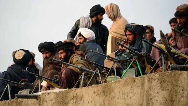 In this photograph taken on November 3, 2015, Afghan Taliban fighters listen to Mullah Mohammad Rasool Akhund (unseen), the newly appointed leader of a breakaway faction of the Taliban, at Bakwah in the western province of Farah - Sputnik International