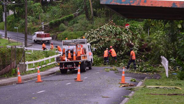 City workers clear fallen trees from a road in Fiji's capital Suva after Cyclone Winston swept across Viti Levu Island, February 21, 2016. - Sputnik International
