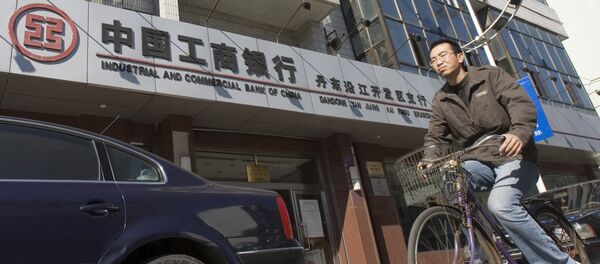 A man rides past a branch of the Industrial and Commercial Bank of China in the border city of Dandong in northeast China A man rides past a branch of the Industrial and Commercial Bank of China in the border city of Dandong in northeast China - Sputnik International
