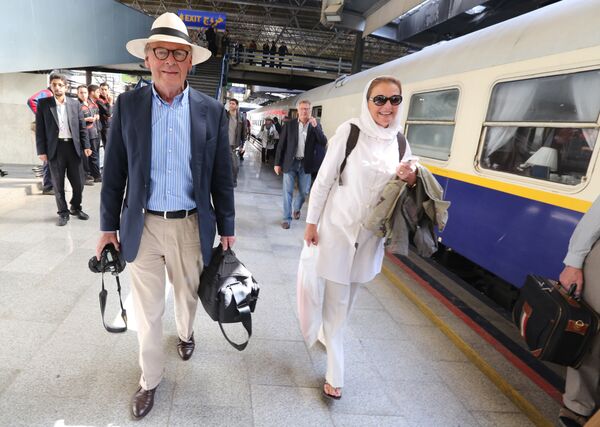 Tourists walk on a platform at a station in Tehran after arriving in the Iranian capital on a luxury train from Budapest Tourists walk on a platform at a station in Tehran after arriving in the Iranian capital on a luxury train from Budapest - Sputnik International