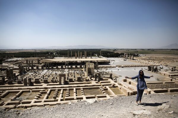 A European woman gestures over the ruins of the ancient Persian city of Persepolis near Shiraz in southern Iran A European woman gestures over the ruins of the ancient Persian city of Persepolis near Shiraz in southern Iran - Sputnik International