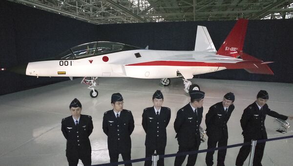 Defense Ministry officers stand in front of the first domestically-made stealth aircraft, X-2, at Nagoya Airport in Toyoyama town, central Japan, Thursday, Jan. 28, 2016. - Sputnik International