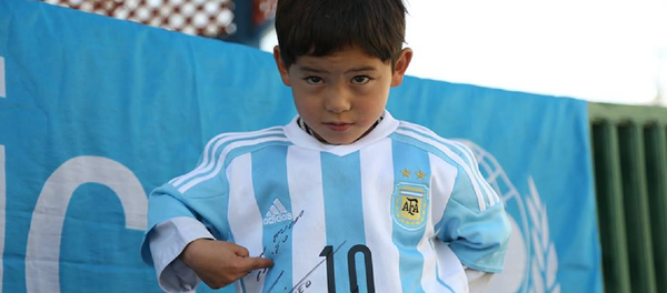 Murtaza Ahmadi can proudly show off the new signed jerseys and a football he received from UNICEF Goodwill Ambassador Leo Messi. Murtaza Ahmadi can proudly show off the new signed jerseys and a football he received from UNICEF Goodwill Ambassador Leo Messi. - Sputnik International