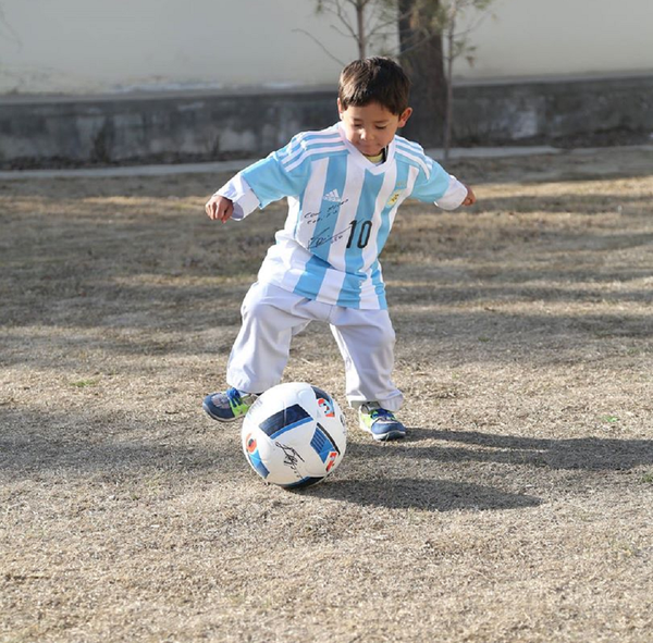 Murtaza Ahmadi can proudly show off the new signed jerseys and a football he received from UNICEF Goodwill Ambassador Leo Messi. Murtaza Ahmadi can proudly show off the new signed jerseys and a football he received from UNICEF Goodwill Ambassador Leo Messi. - Sputnik International