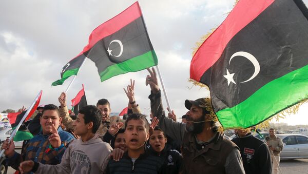 Libyans wave their national flags as they celebrate Libya's eastern government's gains in the area, in Benghazi, Libya, February 24, 2016. - Sputnik International