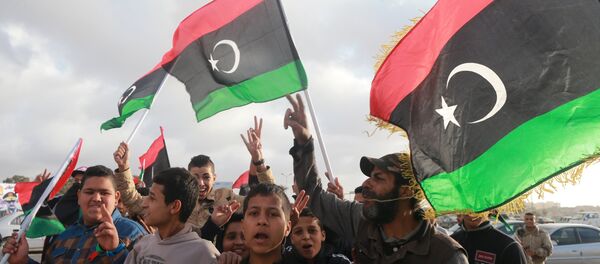 Libyans wave their national flags as they celebrate Libya's eastern government's gains in the area, in Benghazi, Libya, February 24, 2016. Libyans wave their national flags as they celebrate Libya's eastern government's gains in the area, in Benghazi, Libya, February 24, 2016. - Sputnik International