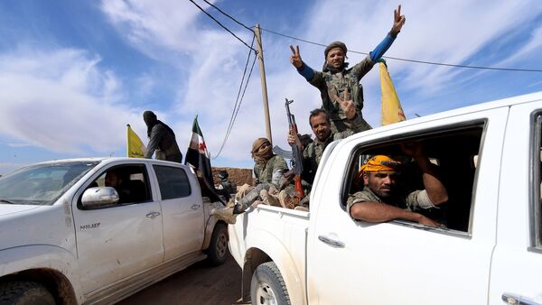 Syria Democratic Forces and Free Syrian Army fighters gesture on the back of pick-up trucks in a village on the outskirts of al-Shadadi town, Hasaka countryside, Syria - Sputnik International