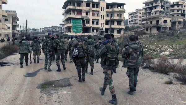 In this photo released on Tuesday, Jan 12, 2016, by the Syrian official news agency SANA, shows Syrian government troops and allied militiamen walk inside the key town of Salma in Latakia province, Syria - Sputnik International