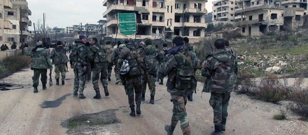 In this photo released on Tuesday, Jan 12, 2016, by the Syrian official news agency SANA, shows Syrian government troops and allied militiamen walk inside the key town of Salma in Latakia province, Syria - Sputnik International