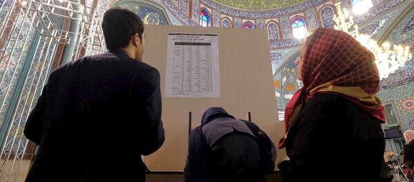 Iranians look at a list of candidates' names during elections for the parliament and Assembly of Experts, which has the power to appoint and dismiss the supreme leader, at a polling station in Tehran February 26, 2016 Iranians look at a list of candidates' names during elections for the parliament and Assembly of Experts, which has the power to appoint and dismiss the supreme leader, at a polling station in Tehran February 26, 2016 - Sputnik International