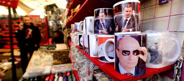 A Syrian vendor sells mugs bearing portraits of Russian President Vladimir Putin (bottom) and Syrian President Bashar Assad (top) in the popular Hamidiyeh market in the old part of the capital Damascus on November 26, 2015 A Syrian vendor sells mugs bearing portraits of Russian President Vladimir Putin (bottom) and Syrian President Bashar Assad (top) in the popular Hamidiyeh market in the old part of the capital Damascus on November 26, 2015 - Sputnik International