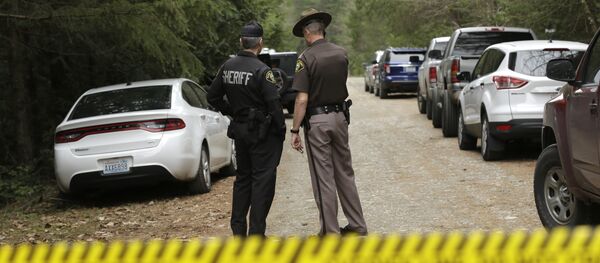 Mason County Sheriff's Chief Criminal Deputies Russ Osterhout, left, and Ryan Spurling, right, stand on a road near the scene of a fatal shooting Friday, Feb. 26, 2016, near Belfair, Wash. Mason County Sheriff's Chief Criminal Deputies Russ Osterhout, left, and Ryan Spurling, right, stand on a road near the scene of a fatal shooting Friday, Feb. 26, 2016, near Belfair, Wash. - Sputnik International