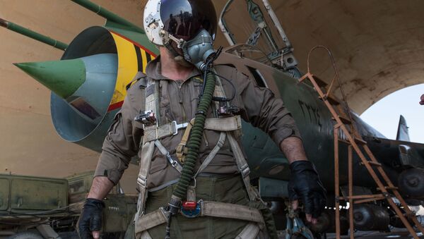 A Syrian pilot prepares for a flight at the Syrian Air Force base in Homs province - Sputnik International