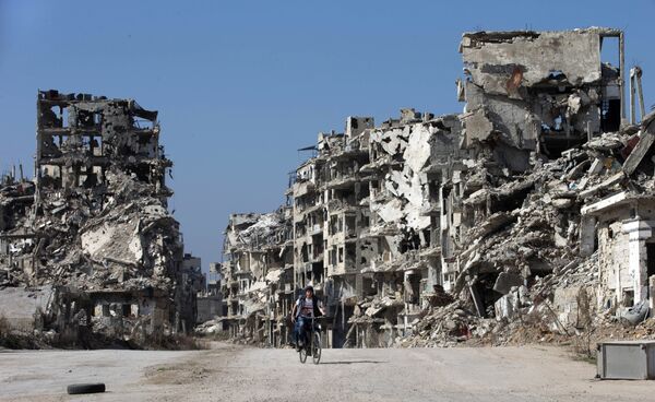 A Syrian boy rides a bicycle through a devastated part of the old city of Homs, Syria, Friday, Feb. 26, 2016 A Syrian boy rides a bicycle through a devastated part of the old city of Homs, Syria, Friday, Feb. 26, 2016 - Sputnik International