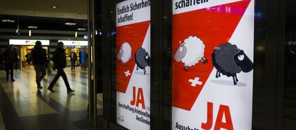 People walk past backlit posters of the right-wing populist Swiss People's Party (SVP) that translate from German as Finally Create Security to advertise their initiative for the eviction of criminal foreigners in Zurich on February 25, 2016 People walk past backlit posters of the right-wing populist Swiss People's Party (SVP) that translate from German as Finally Create Security to advertise their initiative for the eviction of criminal foreigners in Zurich on February 25, 2016 - Sputnik International