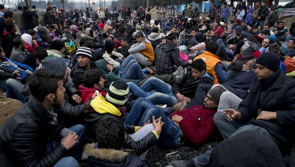 Protesting refugees and migrants block the railway tracks at the Greek-Macedonia border near the northern Greek village of Idomeni, the Sunday, Feb. 28, 2016 - Sputnik International