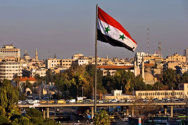 A Syrian national flag waves as vehicles move slowly on a bridge during rush hour, in Damascus, Syria, Sunday, Feb. 28, 2016 A Syrian national flag waves as vehicles move slowly on a bridge during rush hour, in Damascus, Syria, Sunday, Feb. 28, 2016 - Sputnik International