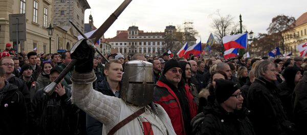 A man dressed as a medieval knight holds a sword during an anti-migrant rally in front of the Prague Castle in Prague, Czech Republic, February 6, 2016 A man dressed as a medieval knight holds a sword during an anti-migrant rally in front of the Prague Castle in Prague, Czech Republic, February 6, 2016 - Sputnik International