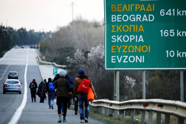 Stranded refugees walk through a national motorway towards the Greek-Macedonian border near the Greek town of Polykastro after ignoring warnings from Greek authorities that the border is shut, as hundreds of migrants set off on the country's main north-south motorway to Idomeni border crossing February 25, 2016. Stranded refugees walk through a national motorway towards the Greek-Macedonian border near the Greek town of Polykastro after ignoring warnings from Greek authorities that the border is shut, as hundreds of migrants set off on the country's main north-south motorway to Idomeni border crossing February 25, 2016. - Sputnik International
