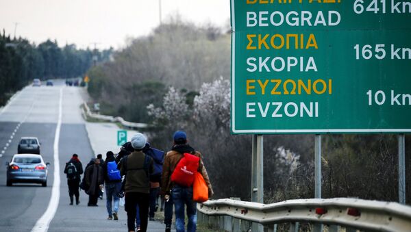 Stranded refugees walk through a national motorway towards the Greek-Macedonian border near the Greek town of Polykastro after ignoring warnings from Greek authorities that the border is shut, as hundreds of migrants set off on the country's main north-south motorway to Idomeni border crossing February 25, 2016. - Sputnik International