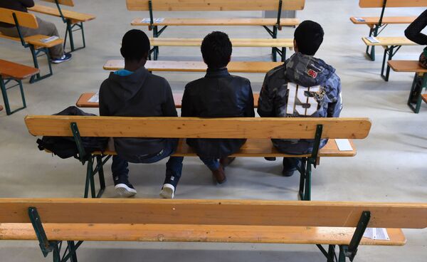 Migrants wait for the start of the rights education lessons for refugees and asylum seekers in a hall of the Bayernkaserne in Munich, southern Germany on February 24, 2016. - Sputnik International