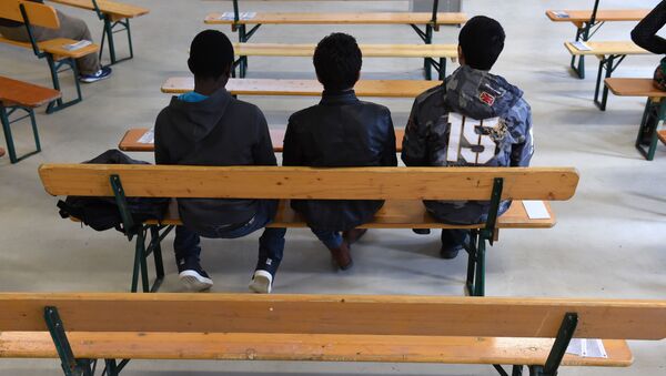 Migrants wait for the start of the rights education lessons for refugees and asylum seekers in a hall of the Bayernkaserne in Munich, southern Germany on February 24, 2016. - Sputnik International