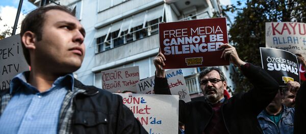 Turkish protesters hold placards outside the headquarters of Bugun newspaper and Kanalturk television station during a demonstration in Istanbul against the Turkish government's crackdown on media outlets (file photo) - Sputnik International