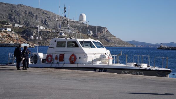 Greek Coast guard officers stand outside their vessel at the port of Kalymnos island. (File) - Sputnik International