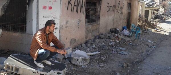 A resident of Cizre sits next to his ruined and burned house. A resident of Cizre sits next to his ruined and burned house. - Sputnik International