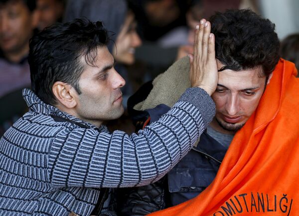 Refugees and migrants sit on board of Turkish Coast Guard Search and Rescue ship Umut-703 off the shores of Izmir, Turkey, after a failed attempt of crossing to the Greek island of Chios, February 28, 2016. - Sputnik International