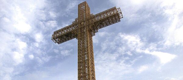 Macedonian Orthodox believers sit around a massive metal cross during its sanctification ceremony on top of Mt. Vodno, just above Macedonia's capital Skopje, on Wednesday, Aug. 28, 2002 Macedonian Orthodox believers sit around a massive metal cross during its sanctification ceremony on top of Mt. Vodno, just above Macedonia's capital Skopje, on Wednesday, Aug. 28, 2002 - Sputnik International