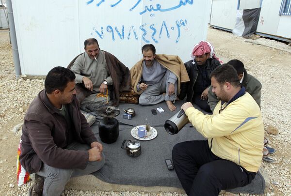A picture taken on March 15, 2014 shows men having tea the sprawling desert Zaatari refugee camp in northern Jordan near the border with Syria which provides shelter to around 100,000 Syrian refugees A picture taken on March 15, 2014 shows men having tea the sprawling desert Zaatari refugee camp in northern Jordan near the border with Syria which provides shelter to around 100,000 Syrian refugees - Sputnik International