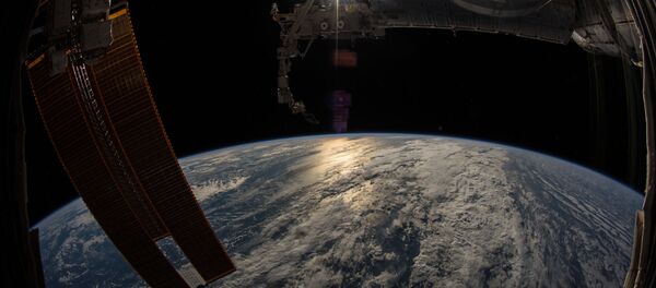 lements of the International Space Station frame this image of the Earth taken Jan. 31, 2016 by the Expedition 46 crew - Sputnik International