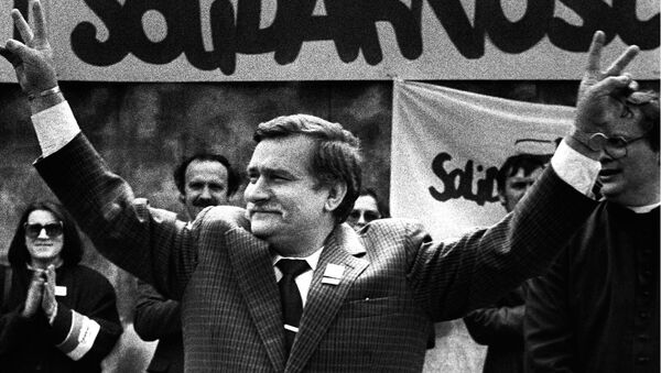 Polish President and Solidarity founding leader Lech Walesa shows v-sign in front of Solidarity poster during his presidential campaign in Plock in this May 7, 1989 file photo - Sputnik International