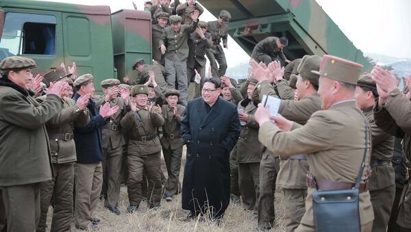 North Korean leader Kim Jong Un (C) smiles as he guides a test fire of a new multiple launch rocket system in this undated photo released by North Korea's Korean Central News Agency (KCNA) in Pyongyang March 4, 2016 - Sputnik International